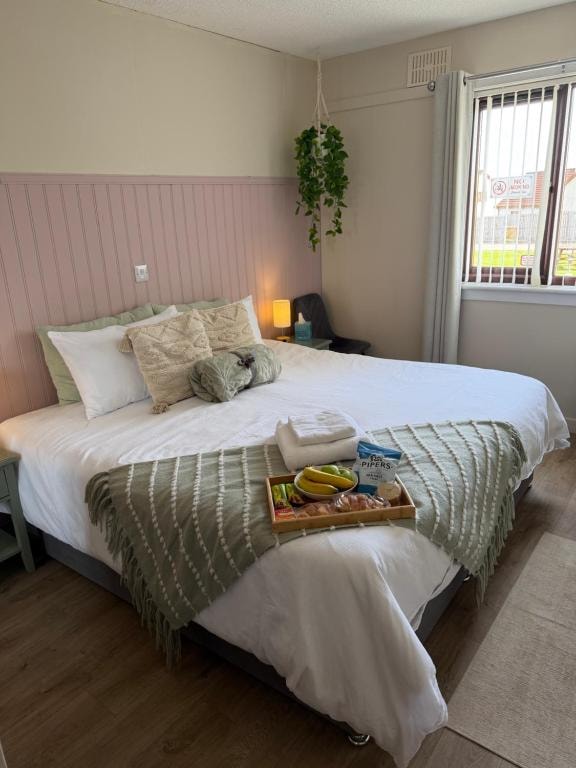 Made-up bed with a breakfast tray at Carnegie Lodgings